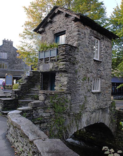 A photograph of the famous 18th century Bridge House in Ambleside in the heart of the Lake District.